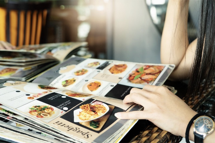 A printed restaurant menu on a dining table