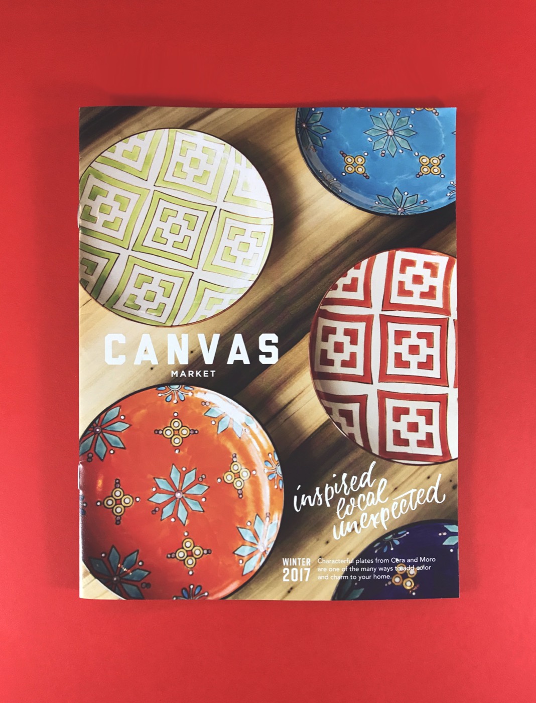 A printed cover with circular pattern art on a red field