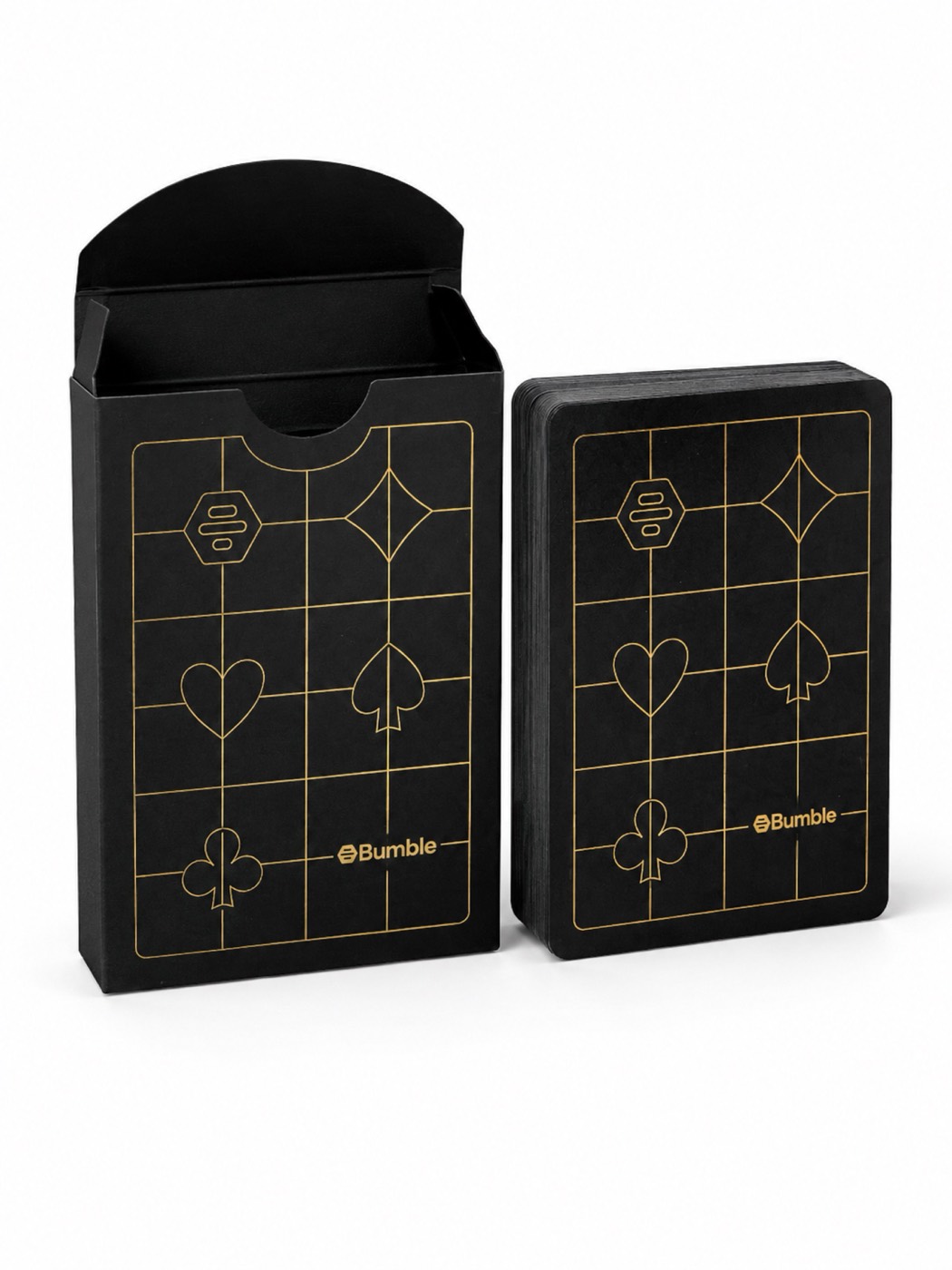 A black tuck box and deck of playing cards with gold foil