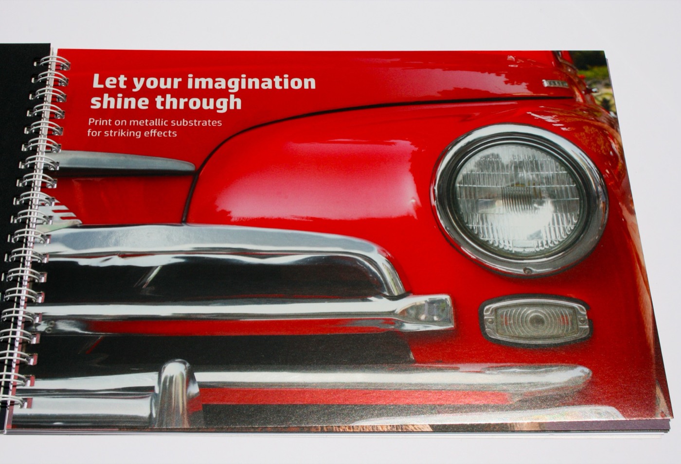A metallic substrate spread with a red car