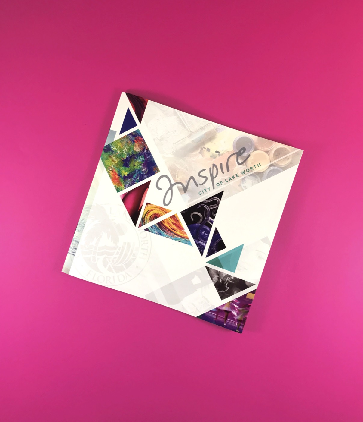 A die-cut printed piece on a hot pink background