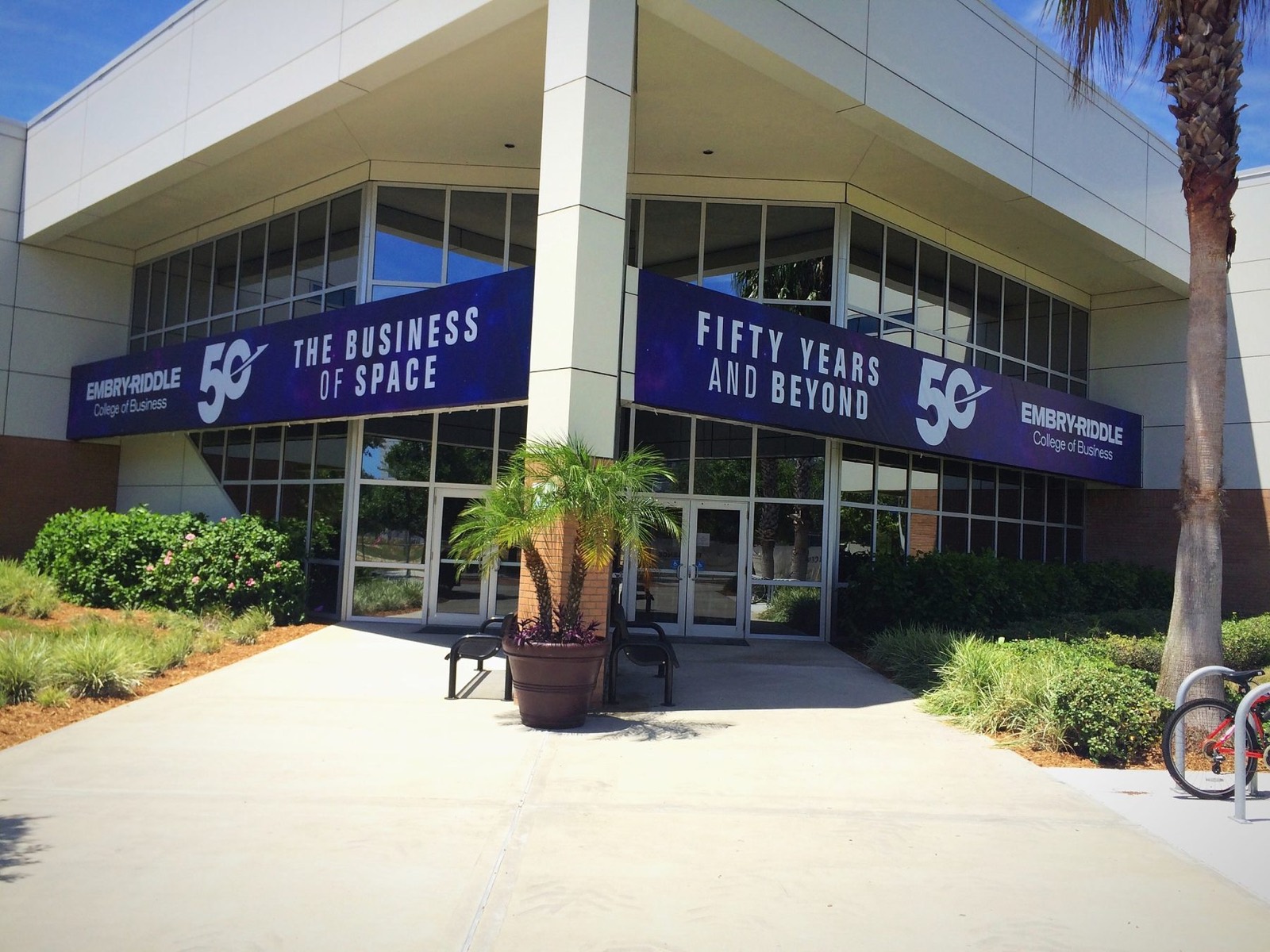 Two large banners across the front of an Embry-Riddle building reading The Business of Space and Fifty Years and Beyond