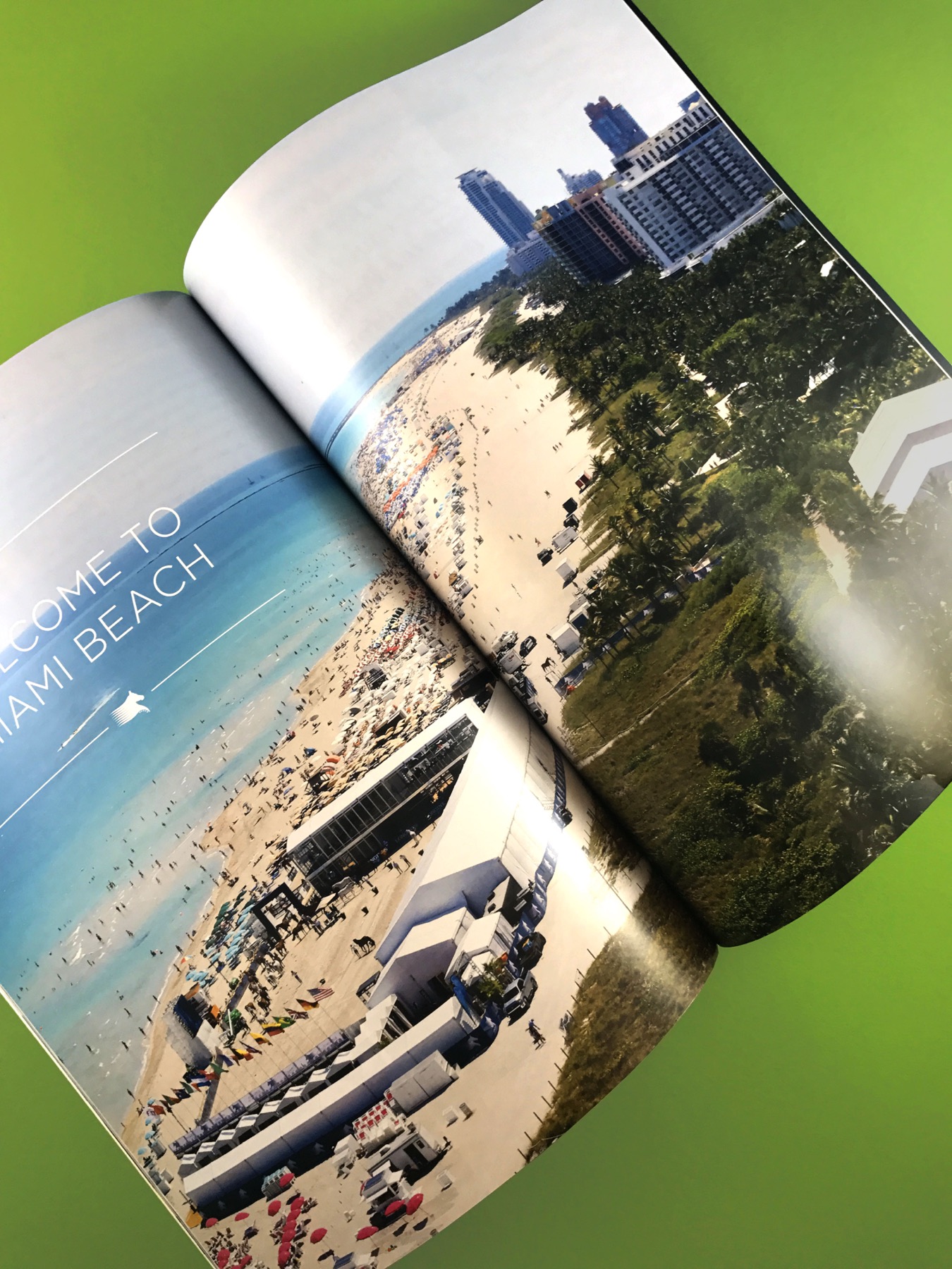 A saddle-stitched program open to a full-bleed spread of Miami Beach, printed in our plant