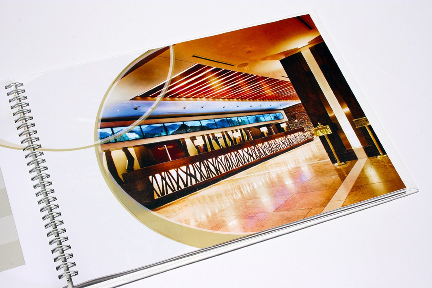 A spiral-bound menu book open to a photograph of the dining room