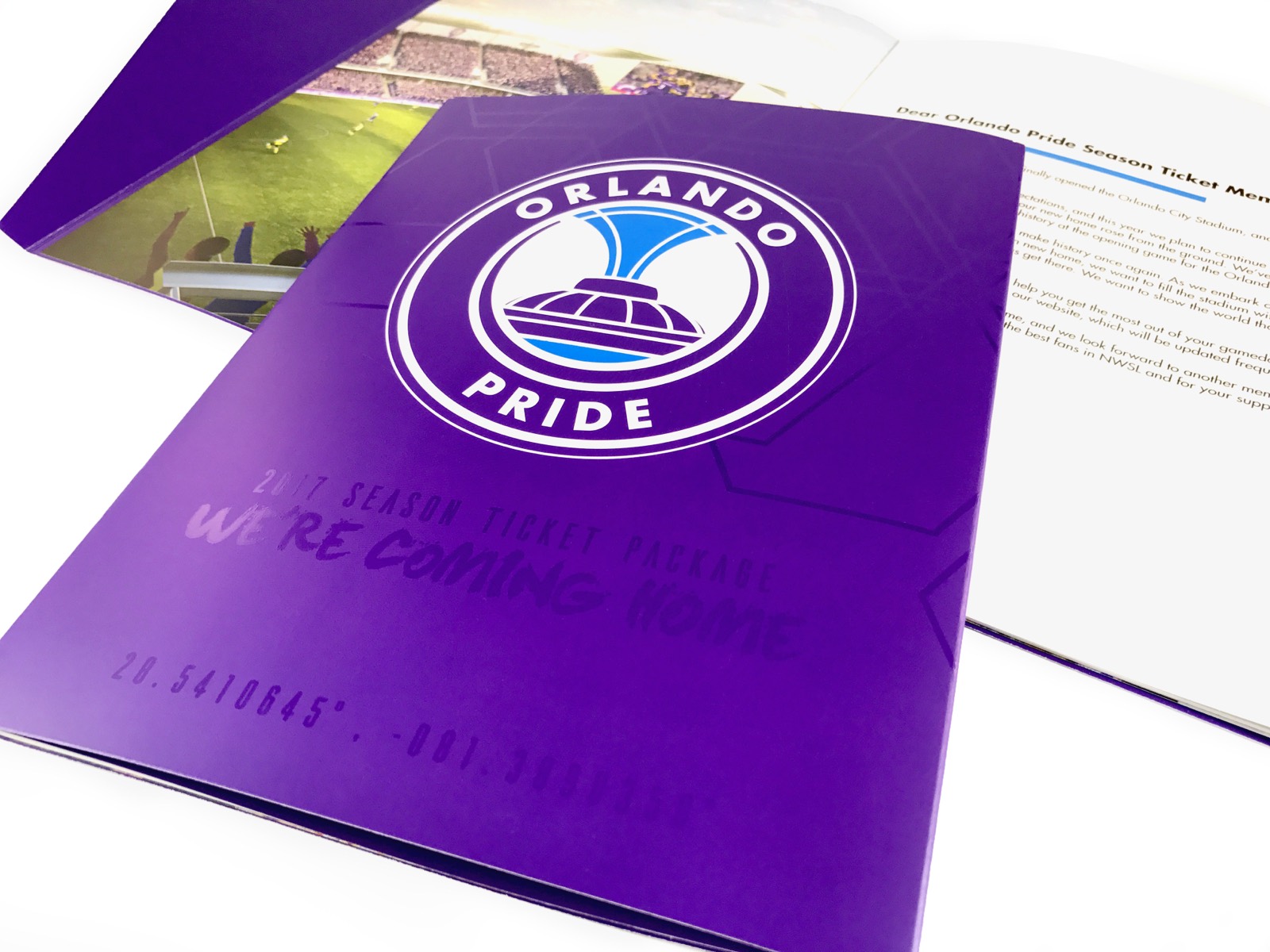 A purple season ticket folder with a spot gloss title, open to a printed insert