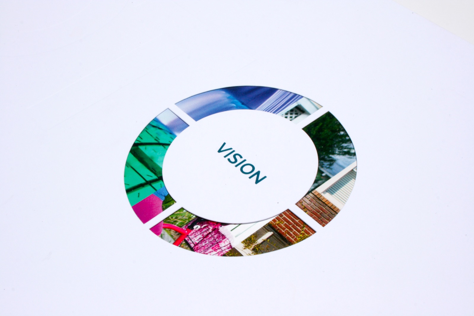 A white die-cut cover with a circle window onto full color photographs