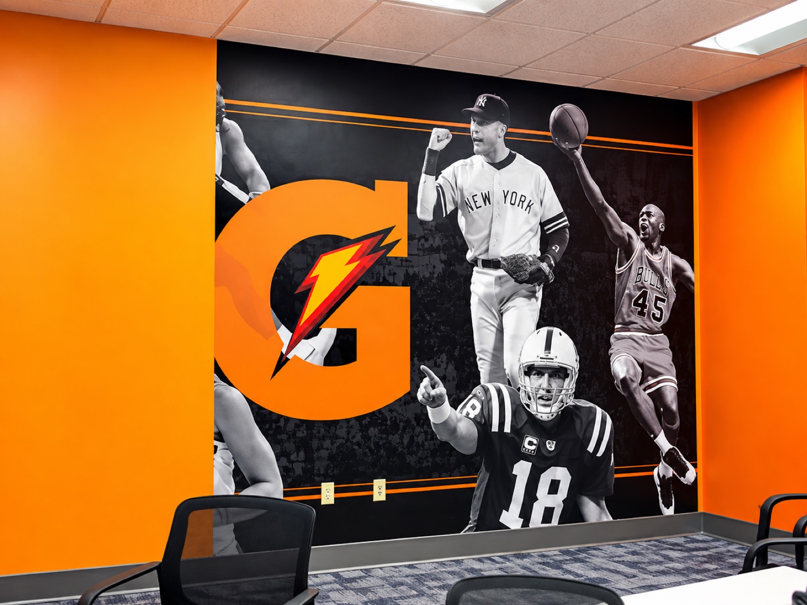 A Gatorade wall mural of athletes running the length of an office wall